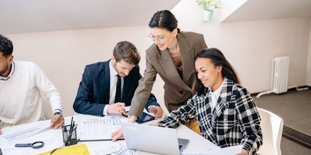 Colleagues collaborating in a modern office during a daytime meeting.